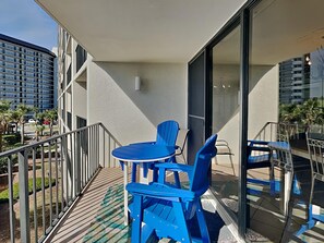Enjoy the view from this stylish balcony with a small table and two chairs.