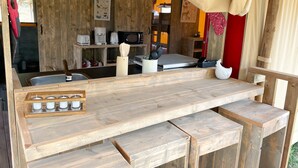 A rustic wooden kitchen with a wooden countertop, a coffee maker, a microwave, and a toaster. - Hitton Séjours Nature (Biran)