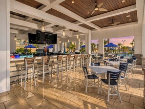 Covered poolside bar and outdoor dining area