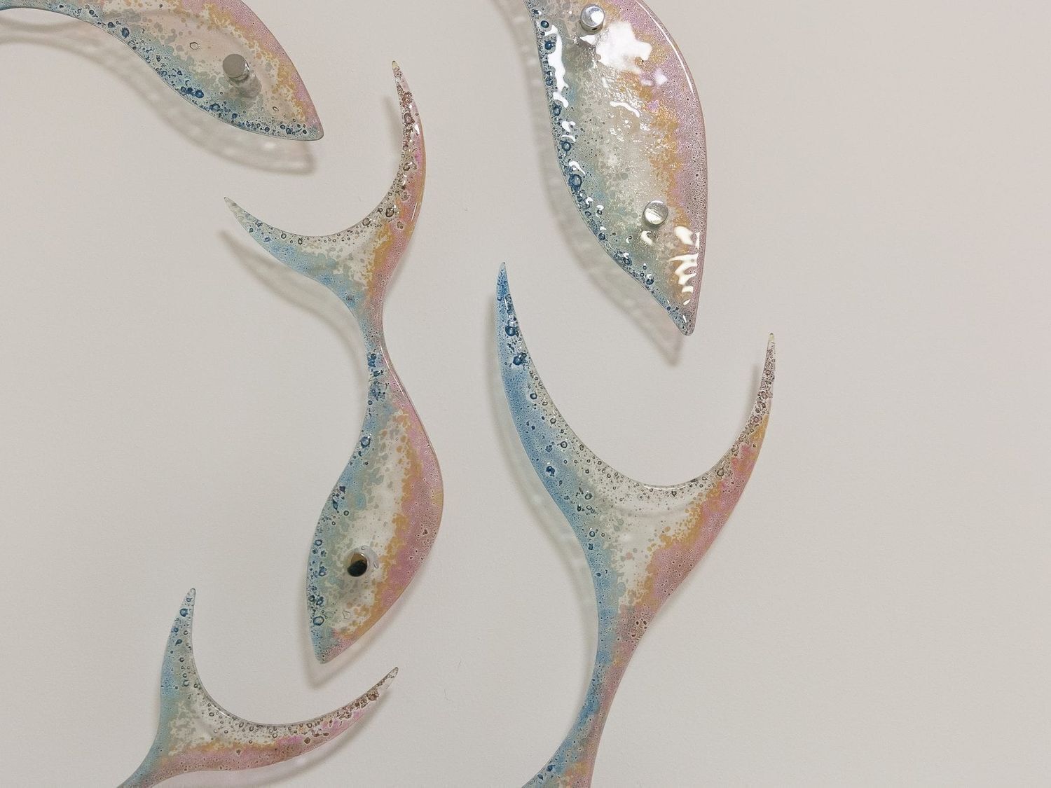 Four fish-shaped decorations with a glossy finish.