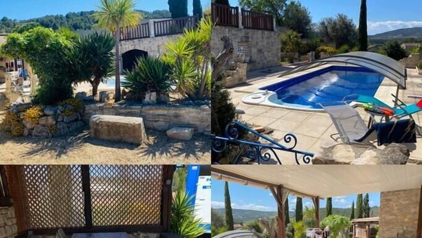 A pool area with a stone wall, lounge chairs, and a covered seating area with a table and chairs. - Le Cabanon (Portel-des-Corbières)