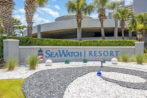 A sign for SeaWatch Resort with a circular garden design. - Beautiful Oceanfront 1 Bedroom Condo at Seawatch Resort (Myrtle Beach)