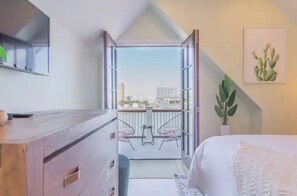 Enjoy the city view from your balcony with a comfortable bed and stylish furnishings.