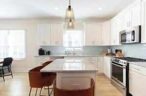 Enjoy cooking in this well-equipped kitchen with a central island, gas stove, and microwave.