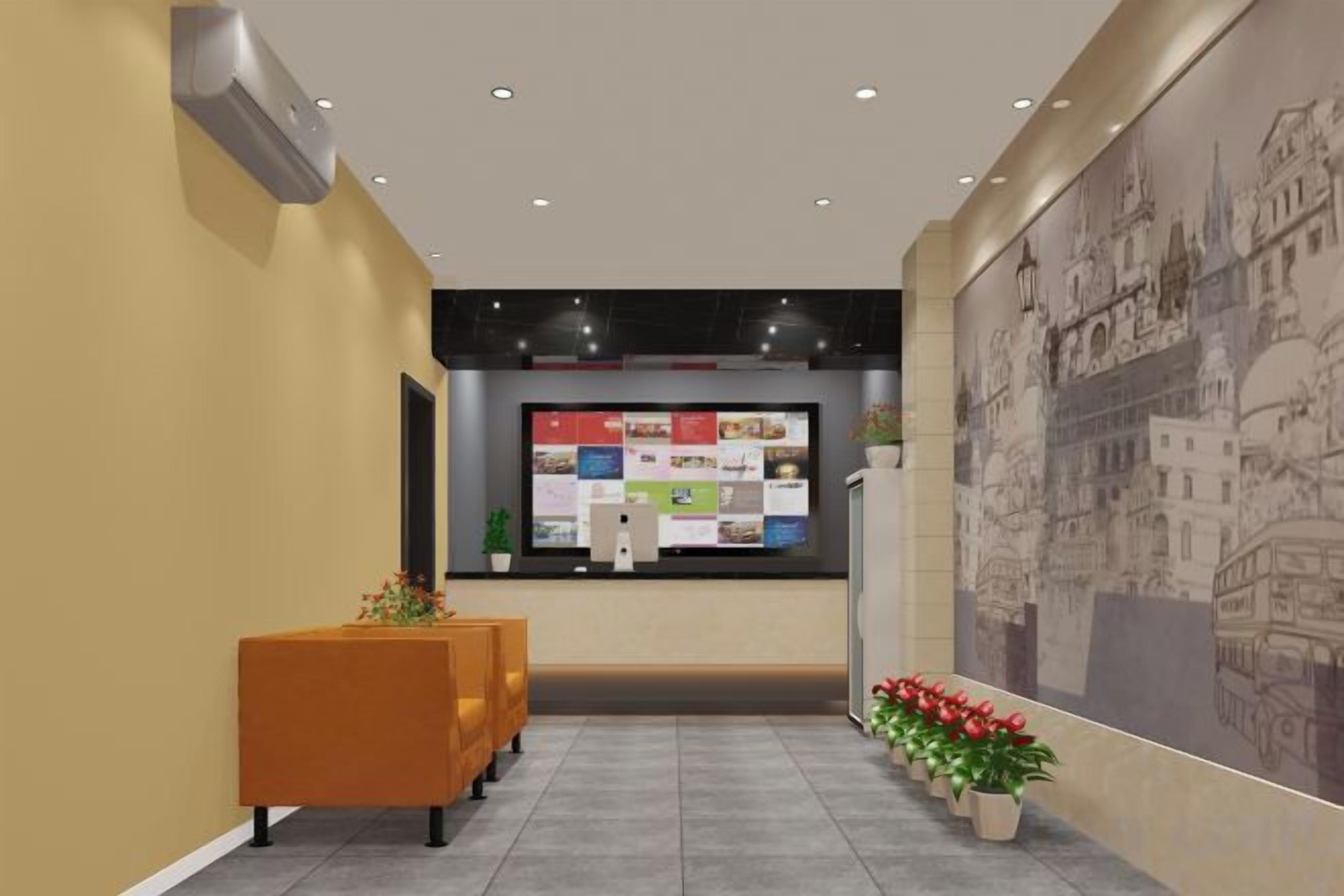 A reception area with a bulletin board, seating, and a large wall mural.