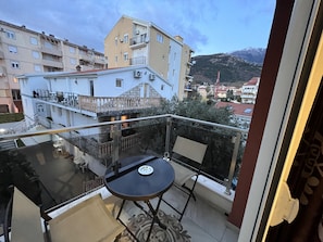Enjoy the serene view of the surrounding mountains from this balcony.
