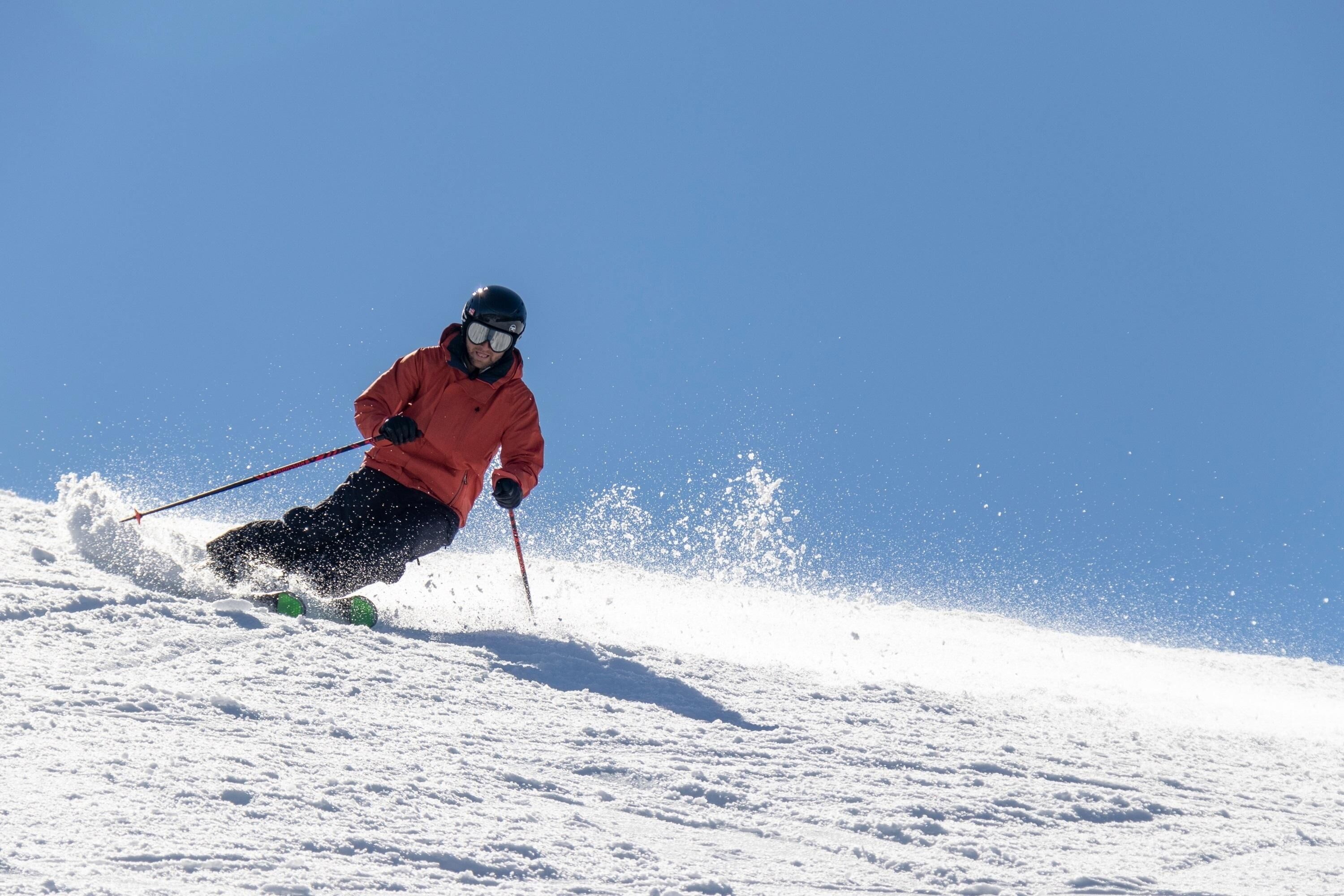 A person skiing down a snowy slope.