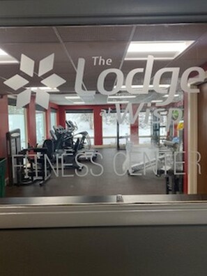 A fitness center with exercise equipment and a sign reading "The Lodge Fitness Center". - The Lodge at Wisp Resort (McHenry)