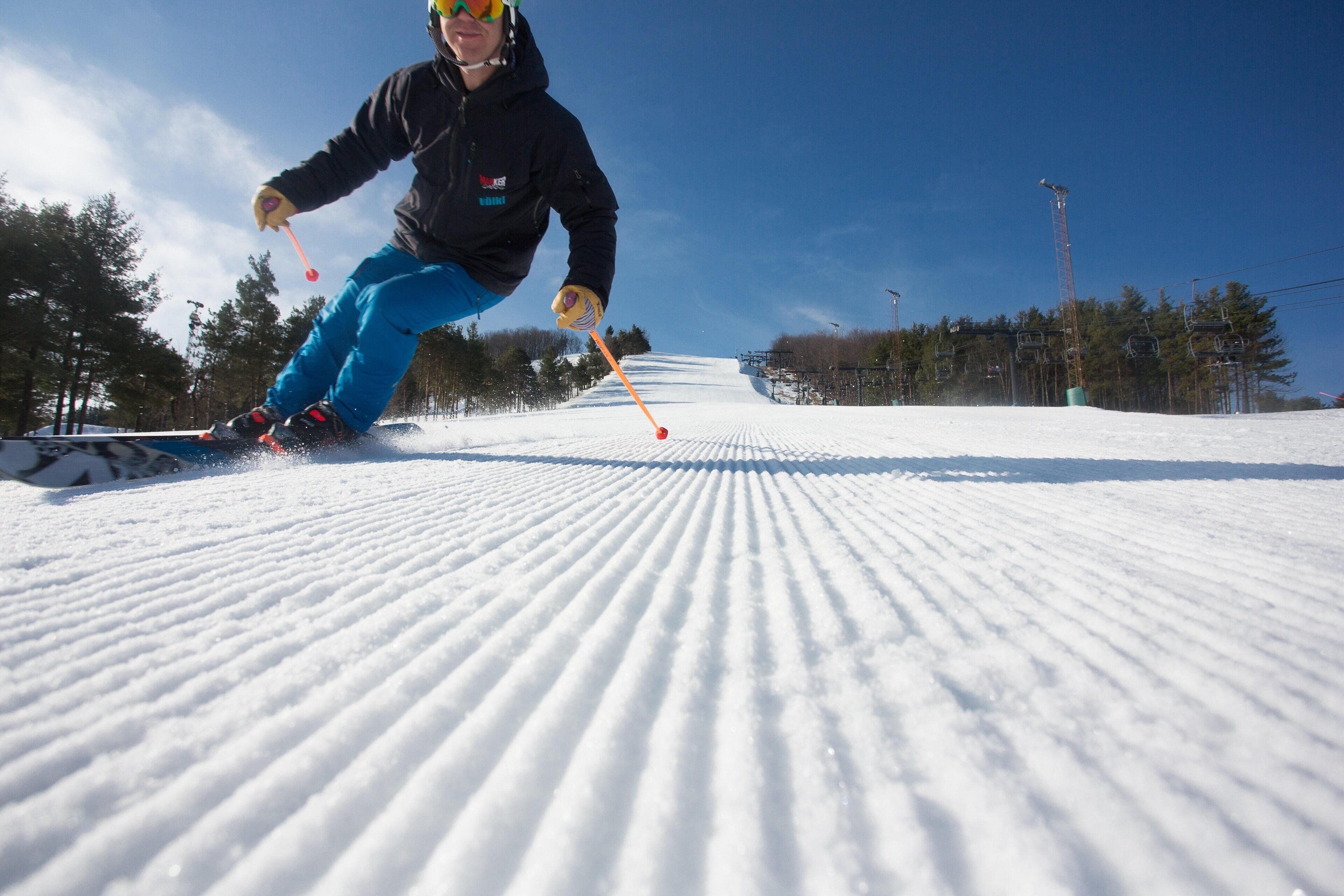 A person skiing down a snow-covered slope.