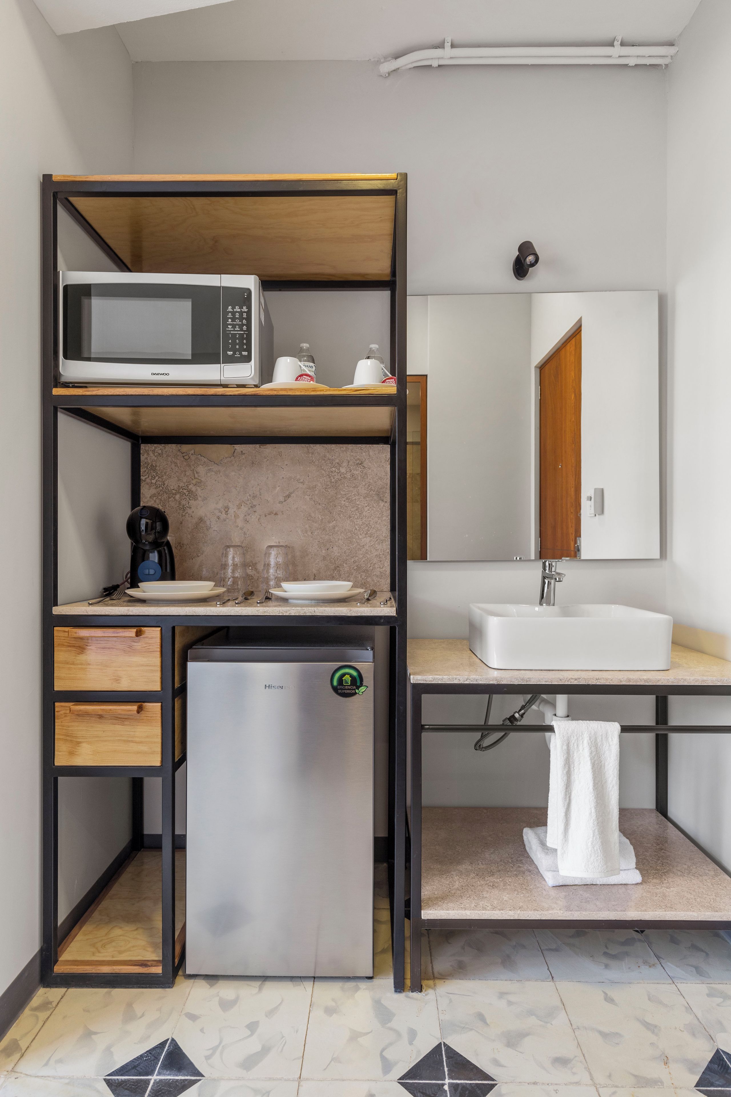 A compact kitchenette with a microwave, coffee maker, and mini-fridge.
