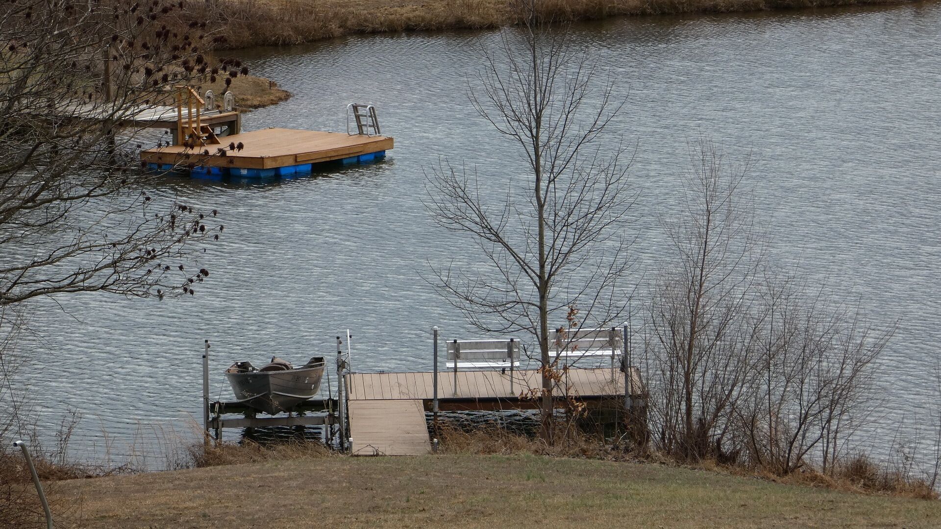 A dock with a boat and a small wooden structure.