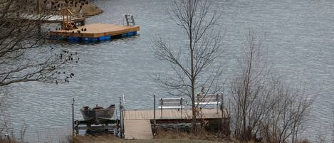 A dock with a boat and a small wooden structure.