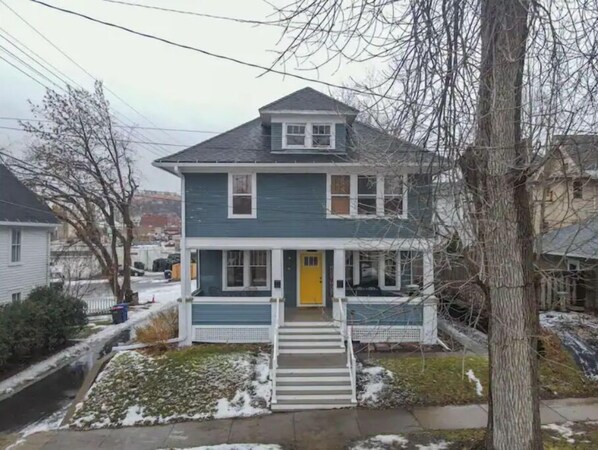 Enjoy the charm of this two-story home with a welcoming front porch and a beautifully landscaped yard.