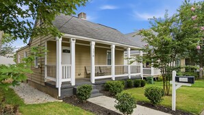 A two-story house with a front porch, a mailbox, and a well-maintained lawn. - NEW! 3 Br Home Steps away from Stadium & Downtown! (Atlanta)