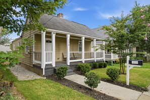 A two-story house with a front porch, a mailbox, and a well-maintained lawn. - NEW! 3 Br Home Steps away from Stadium & Downtown! (Atlanta)