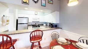 Enjoy cooking in this fully equipped kitchen with a refrigerator, stove, and microwave.