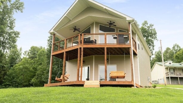 A two-story house with a balcony and a covered porch.