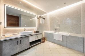 A modern bathroom with a large mirror, a sink, a bathtub, and a shower. - Tianju Caohai Holiday Hotel (Weining)