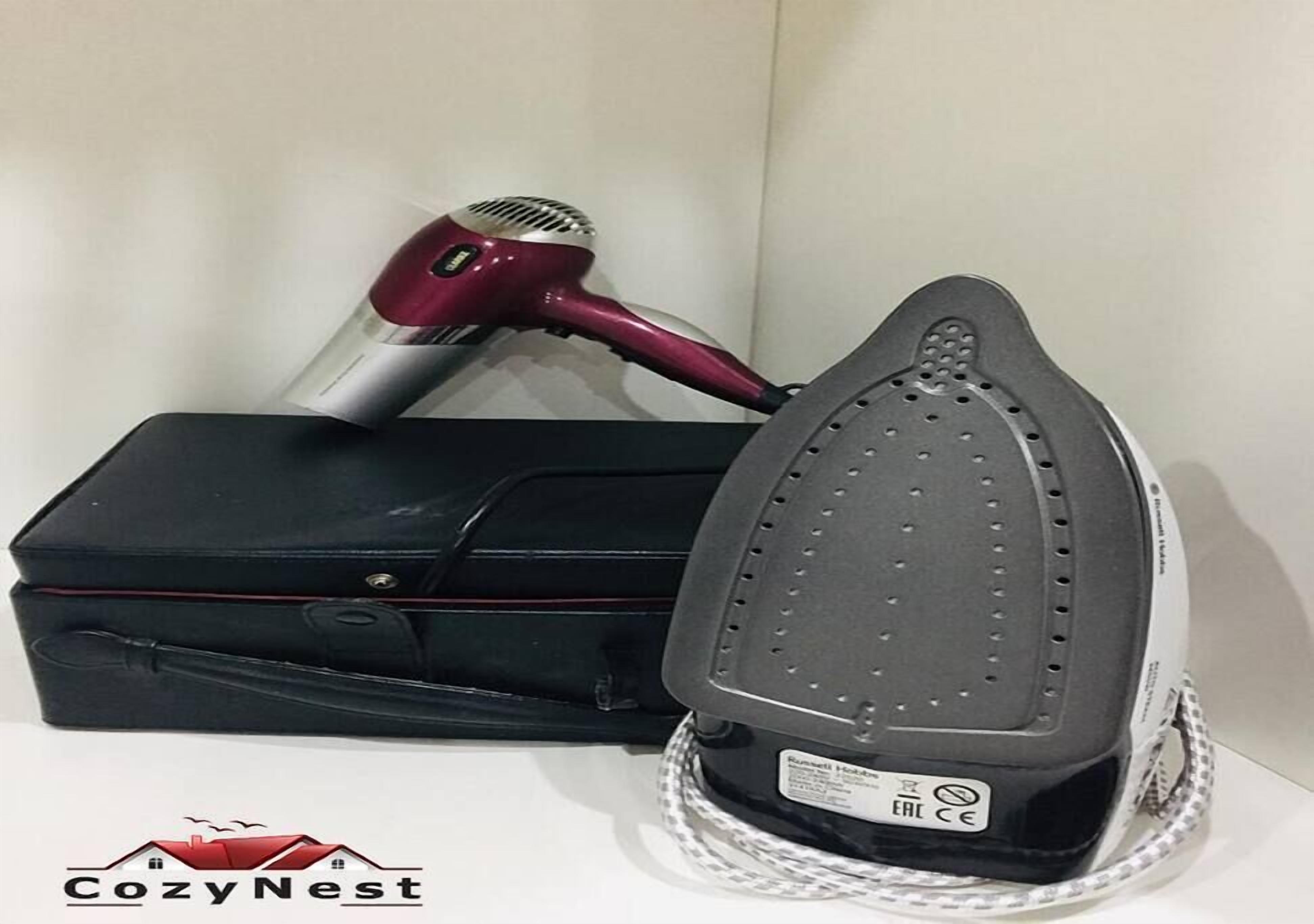 A suitcase, a hair dryer, and an iron.