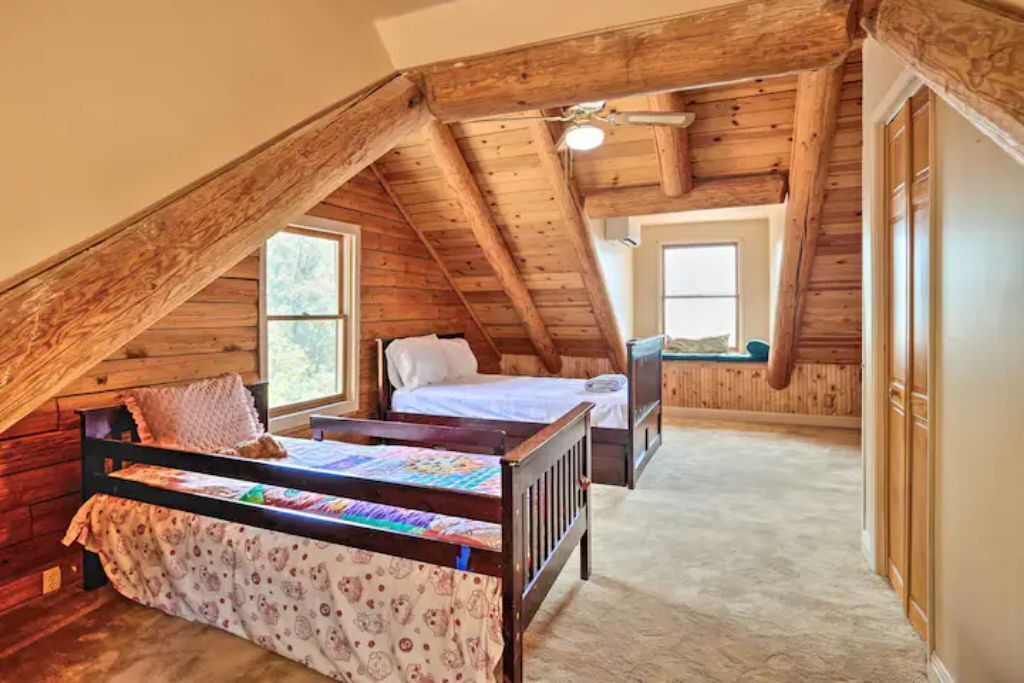 Spacious yet warm upstairs bedroom with two beds with ample natural light
