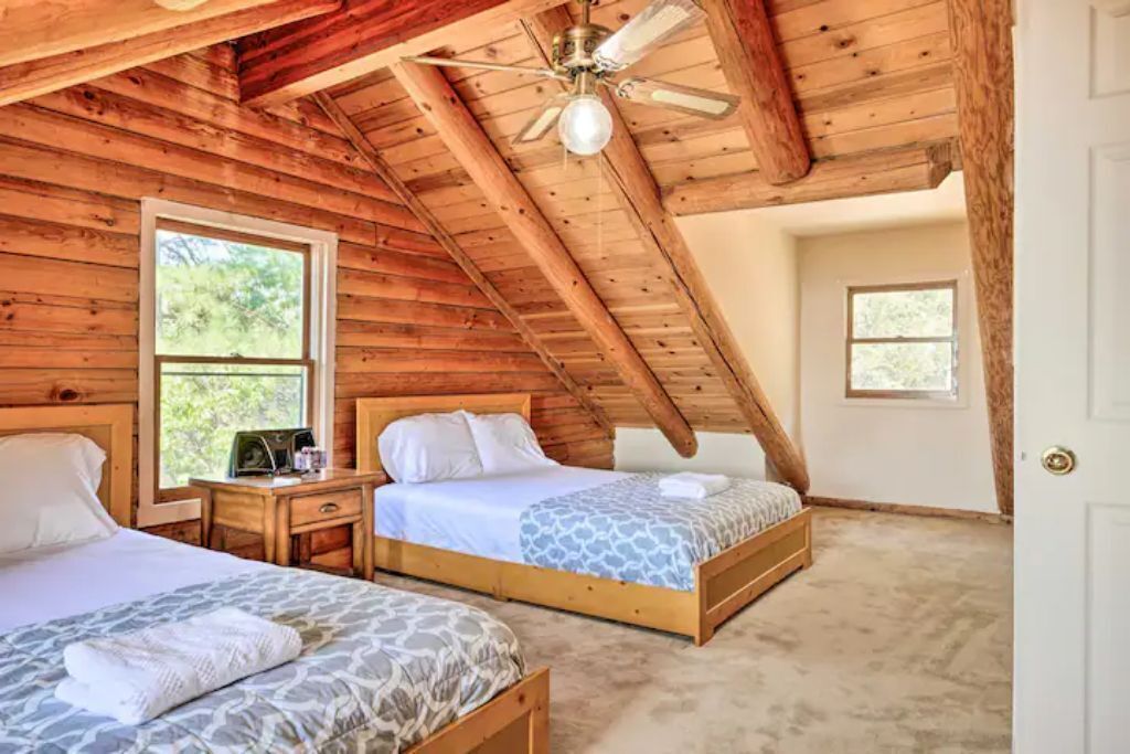 Spacious yet warm upstairs bedroom with two queen beds with ample natural light