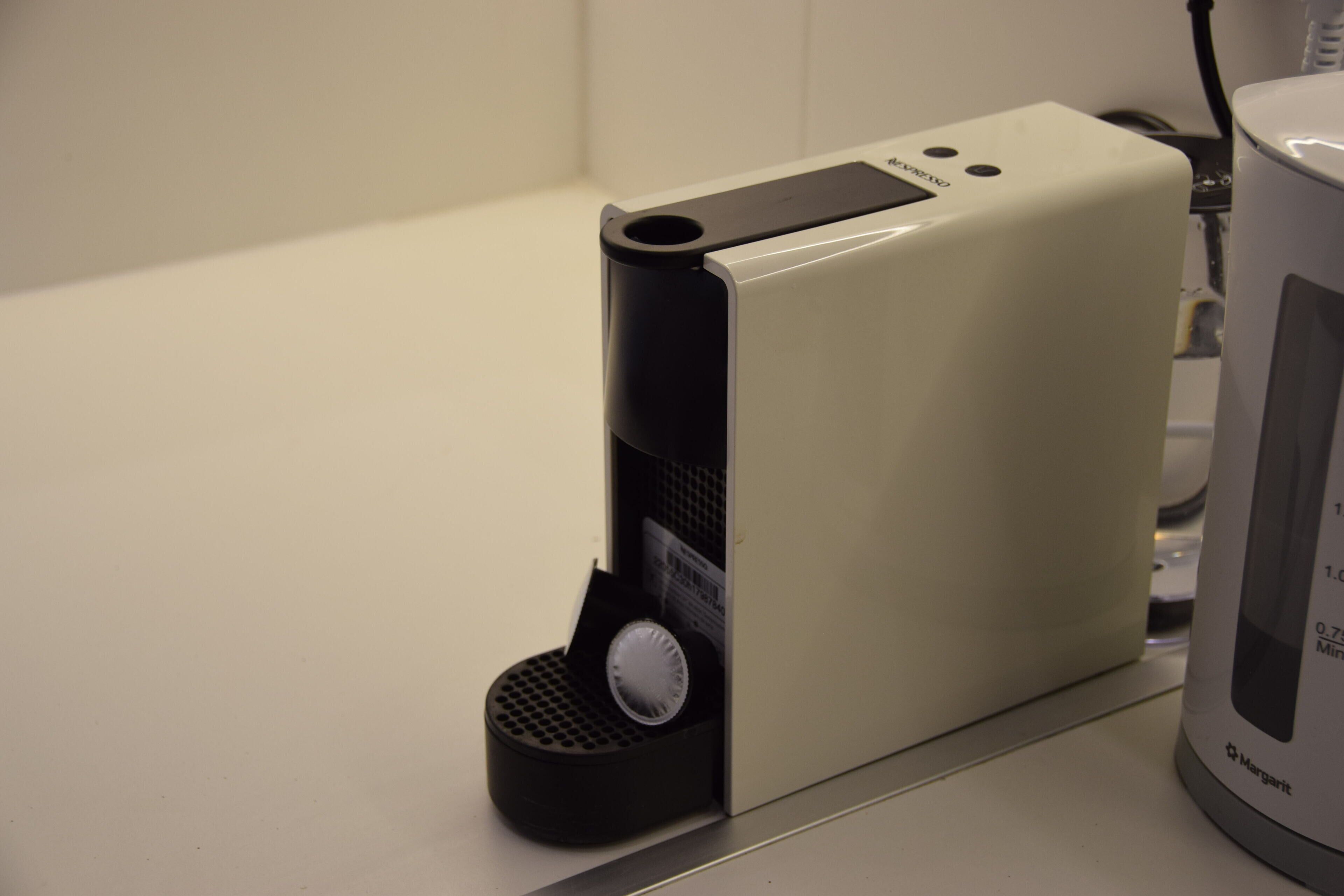 A coffee machine with a control panel and a coffee pot.