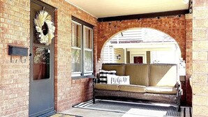 A brick exterior with a front door, a welcome mat, a bench, and a wreath. - Peaceful & Clean Getaway/3BR-By KWU & DnTown (Salina)
