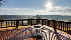 A wooden deck with a fire pit, overlooking a mountainous landscape. - Water-View Home Half Mile to Table Rock Lake (Green Forest)