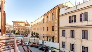 A street view with parked cars and buildings. - Saint Peter House Station Deluxe (Roma)