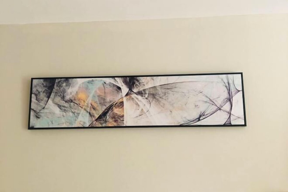 A large abstract painting on a plain wall.