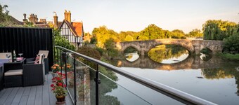 Contemporary riverside retreat with views across the water and historic bridge