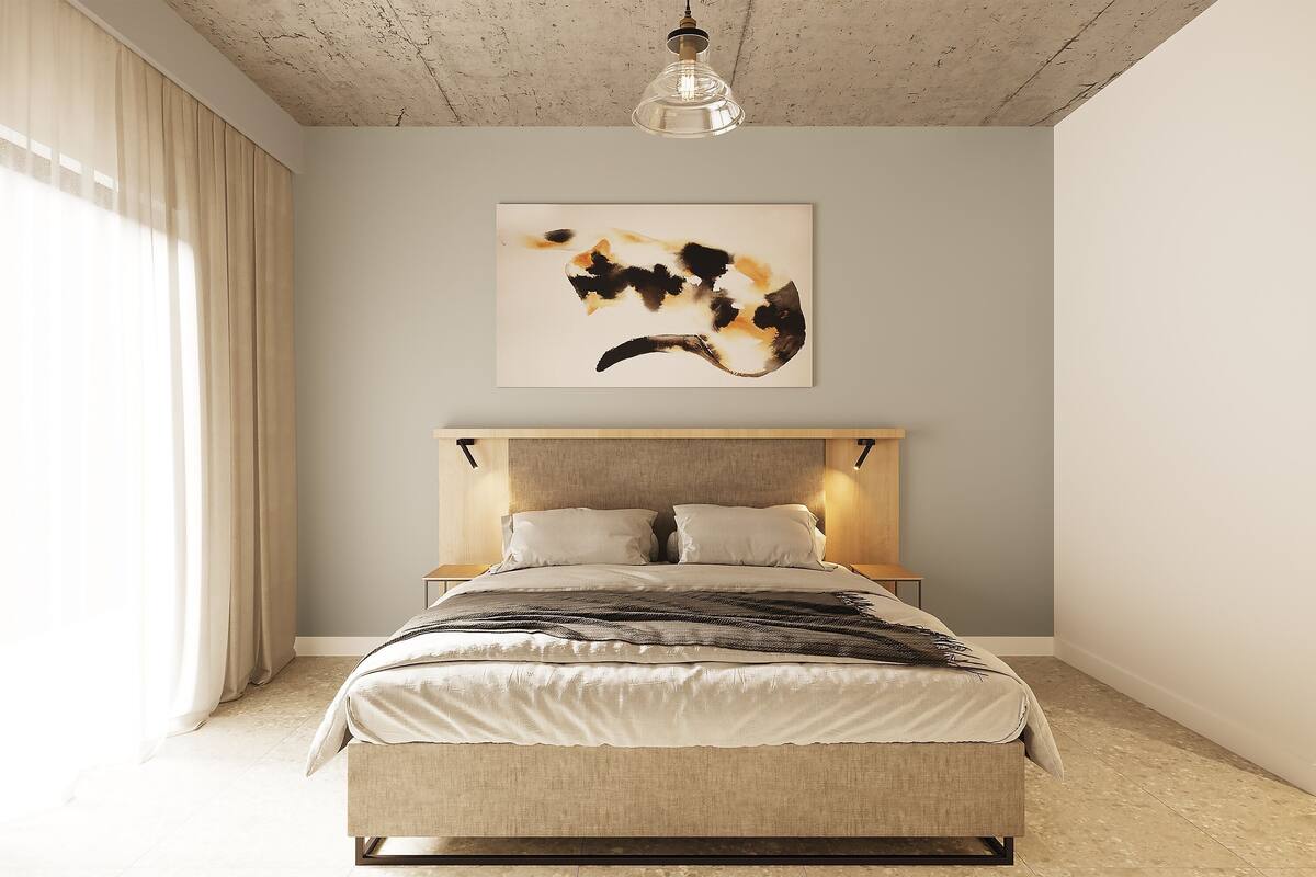 A bedroom with a bed, headboard, bedside tables, and a ceiling light fixture.