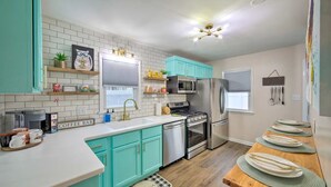 A modern kitchen with teal cabinets, a stainless steel refrigerator, and a coffee bar. - *New* < 3 Miles to Beach + Casino + Zoo + Shopping! (Michigan City)