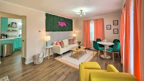 A modern living room with a white sofa, green chairs, and a yellow armchair. There is a kitchen in the background with teal cabinets and a coffee machine. - *New* < 3 Miles to Beach + Casino + Zoo + Shopping! (Michigan City)