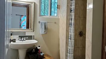 Shower, rainfall showerhead, hair dryer, towels