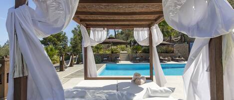 A heated pool, sun loungers