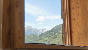 A window with a view of a mountainous landscape. - Chalet ski hut holiday home (Flattach)