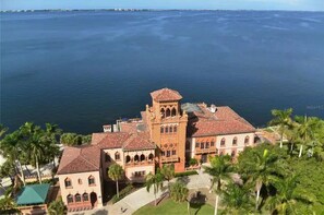 A coastal building with a tower, surrounded by palm trees and a view of the sea. - Your special private slice of Paradise for your get away, 100%  5 stars. (Sarasota)