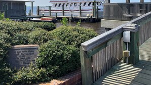 A dock with a boat named 'Camberland Lady' and a public pavilion. - Cumberland Queen Cottage (St Marys)