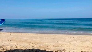 A beach with a clear sky and calm sea. - DownWinder- Spacious 3 BR House - Walk to Beach (Kitty Hawk)