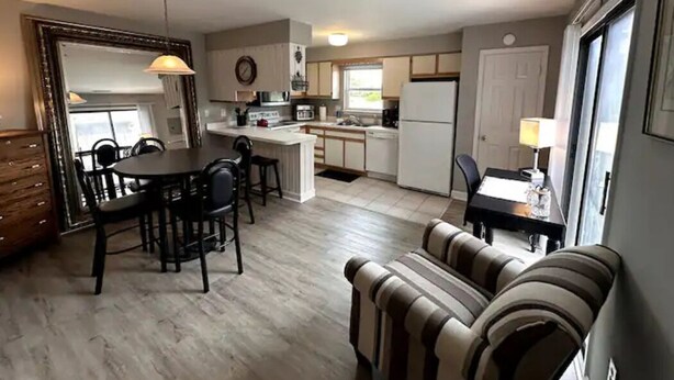 A compact living space with a dining area, kitchenette, and a sofa. - KH Escape! Pool+Tennis+Basketball+0.8 mi to Beach! (Kitty Hawk)