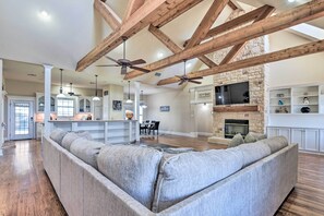 Cozy living area with a fireplace, flat-screen TV, and dining space.
