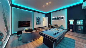 Une chambre moderne équipée d’une table de billard, d’un téléviseur et de jeux d’arcade.