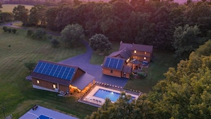 A residential property with a swimming pool, solar panels, and a large lawn. - Luxury Retreat in the heart of Perry County, PA. There are plenty of amenities for the whole family to enjoy! (Elliottsburg)