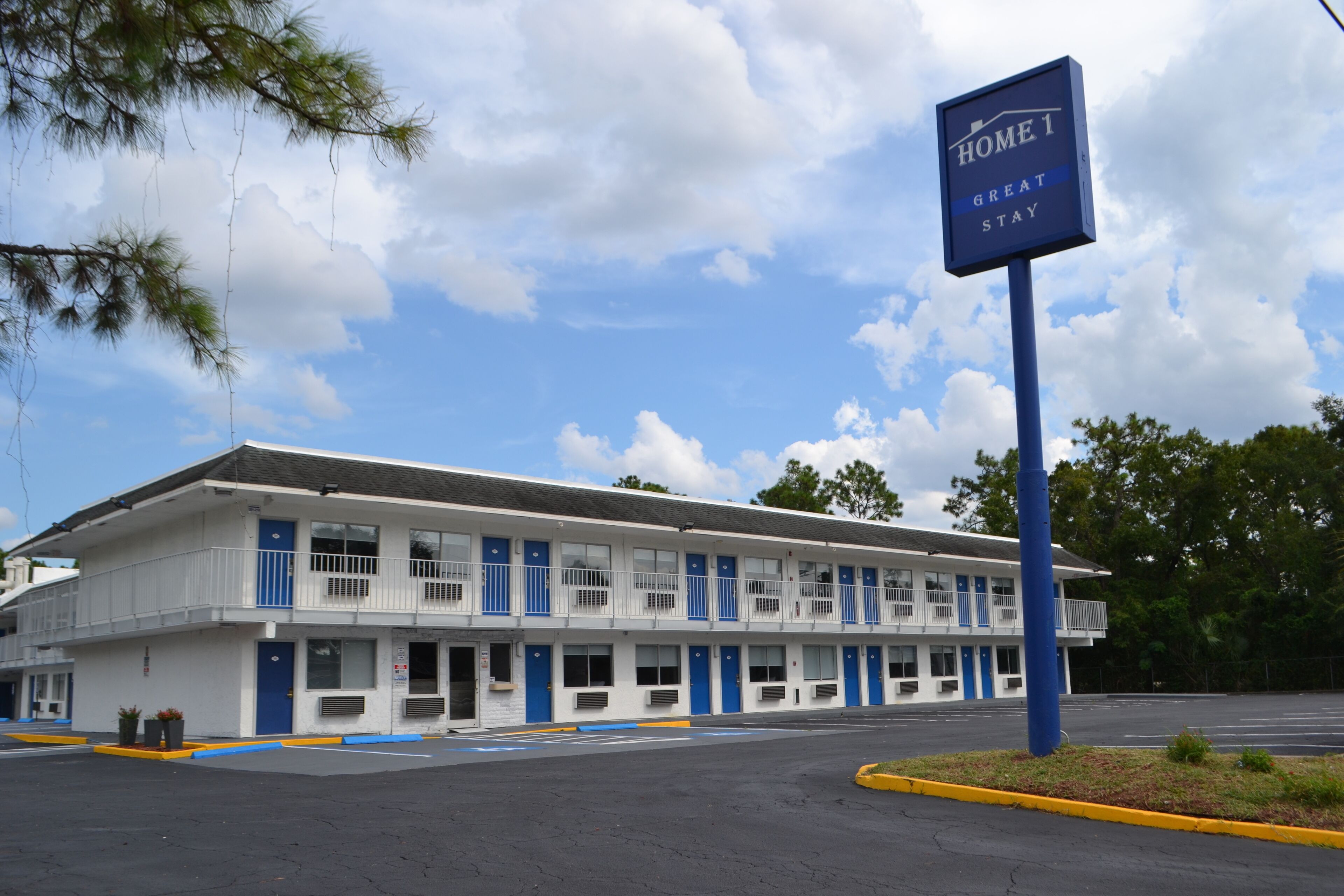 Un motel avec une enseigne sur laquelle on peut lire : « HOME 1, UN SÉJOUR INOUBLIABLE ».
