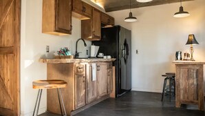 A kitchen with wooden cabinets, a black refrigerator, and pendant lighting. - Little Bit Farm - Create your own stay (Canton)