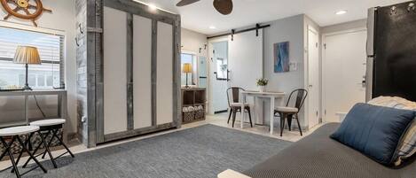 A modern bedroom with a bed, a desk, and a chair.