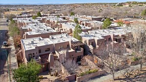 A residential area with multiple two-story buildings, flat roofs, and a clear sky. - Corazon Condo Unit 2, 2 Bed / 2 Bath, Luxury Style Condo (Santa Fe)