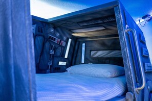 A narrow, enclosed space with a bunk bed, a small table, and a wall-mounted light fixture. - 6BR Magic Mansion – Ultimate Disney Escape (Four Corners)