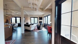 A spacious living area with a sofa, chairs, a dining table, and a kitchen area. - The Lincoln 501, 2 Bed / 2.5 Bath, Luxury Condo (Santa Fe)